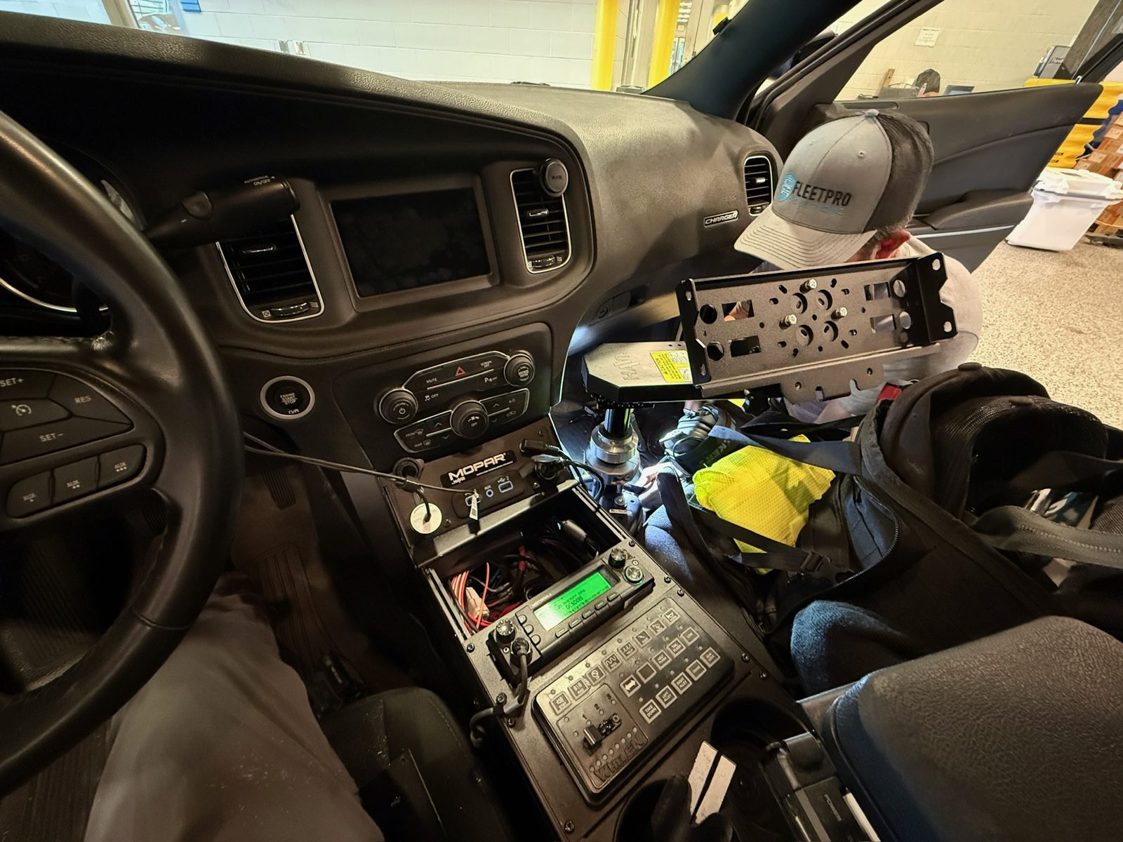Fleet Pro technician installing a mount in a patrol vehicle
